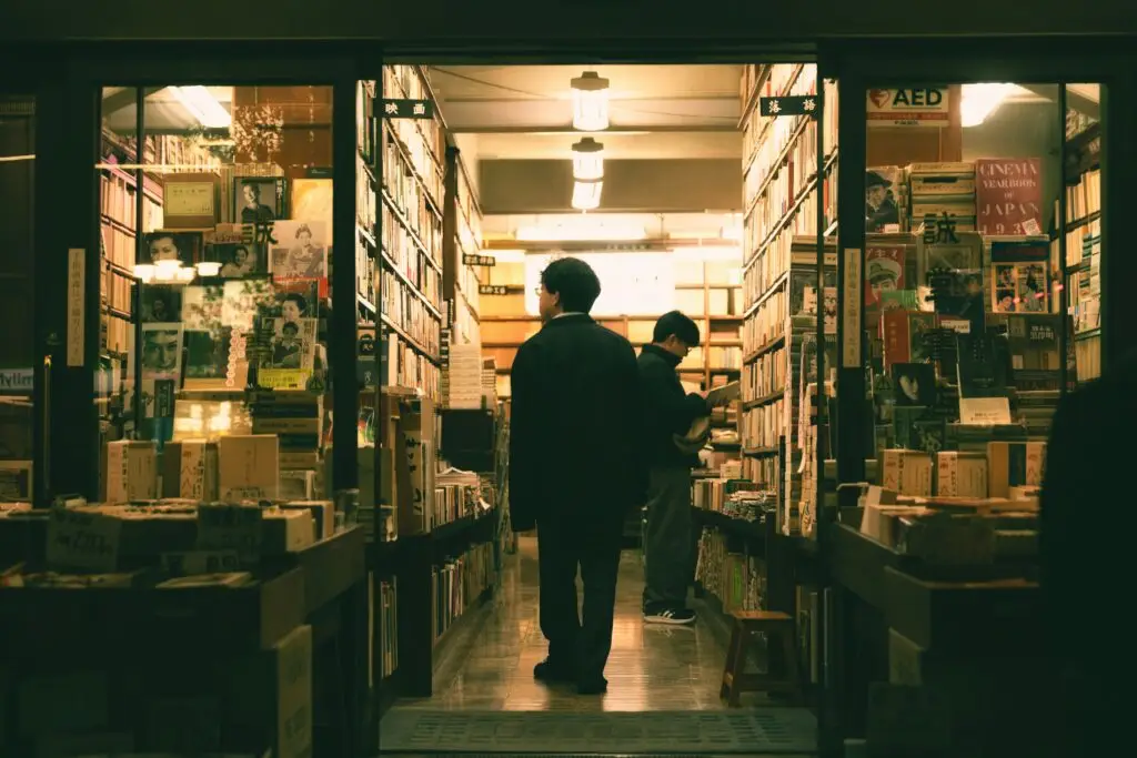 a man leisurely browsing book selections in a Japanese book store