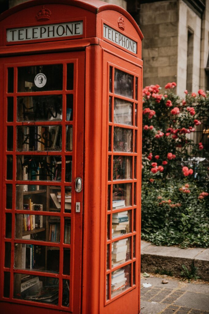classic british red telephone booth filled with books